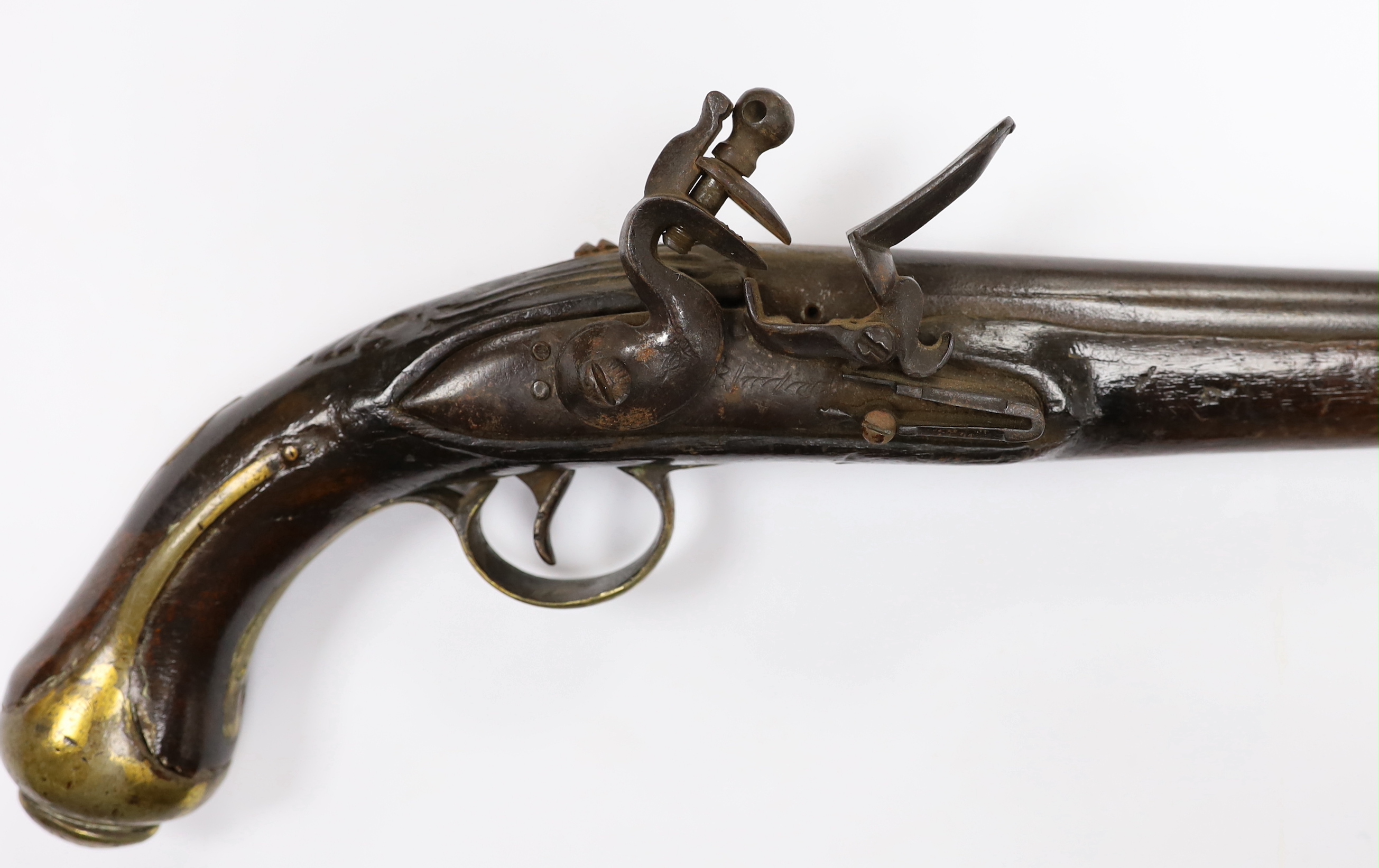An early 19th century Balkan flintlock holster pistol. with limited engraving to lock and barrel and brass mounts (a.f.)